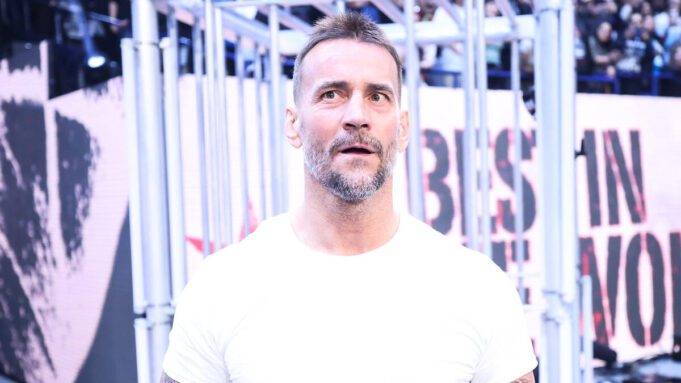 CM Punk in front of a cage at WWE Survivor Series 2023