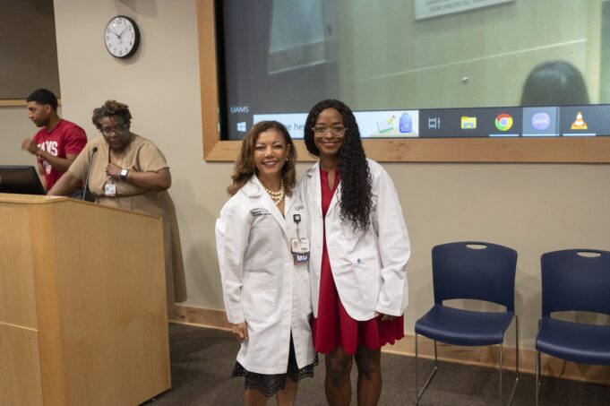 Natasha Wilhelm, a pre-med summer scholar, poses with Gloria Richard-Davis, M.D., in her newly presented white coat.
